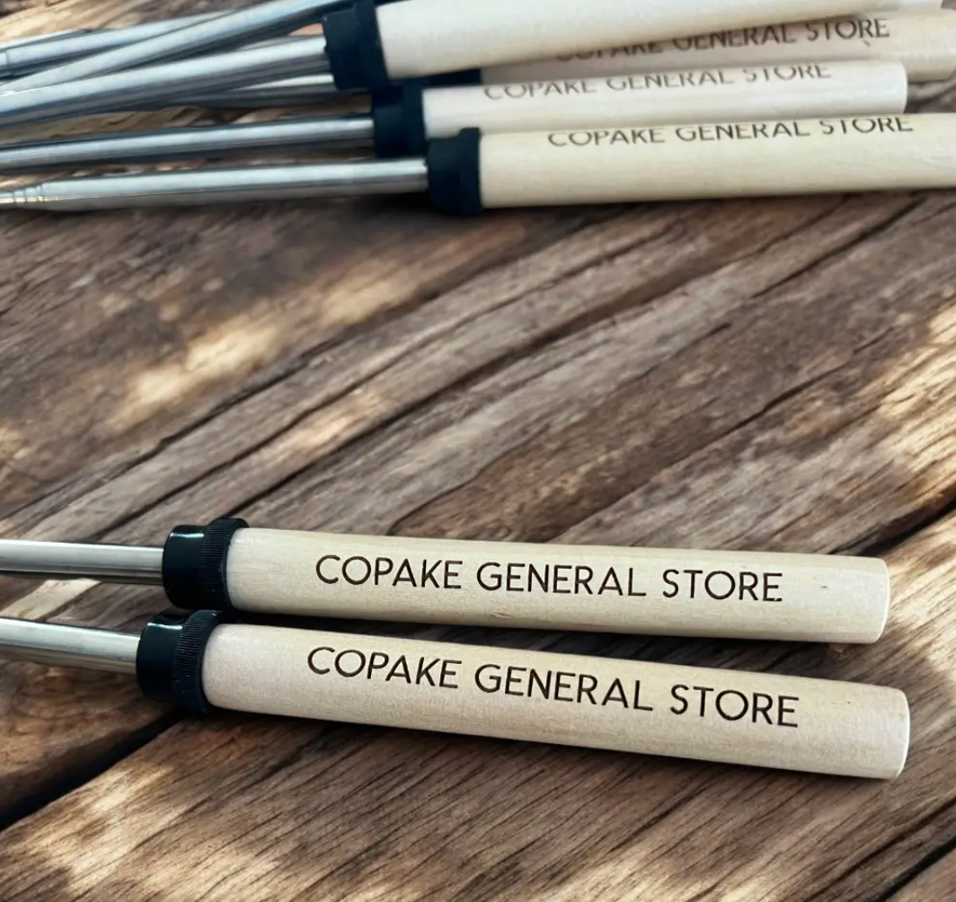Custom engraved marshmallow roasting sticks for general store gift shops — personalized smores sticks with store name laser engraved in bulk