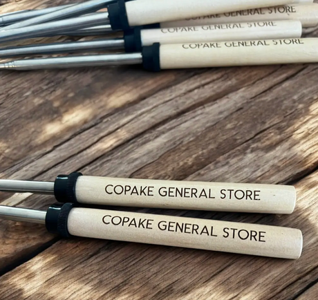 Custom engraved marshmallow roasting sticks for general store gift shops — personalized smores sticks with store name laser engraved in bulk